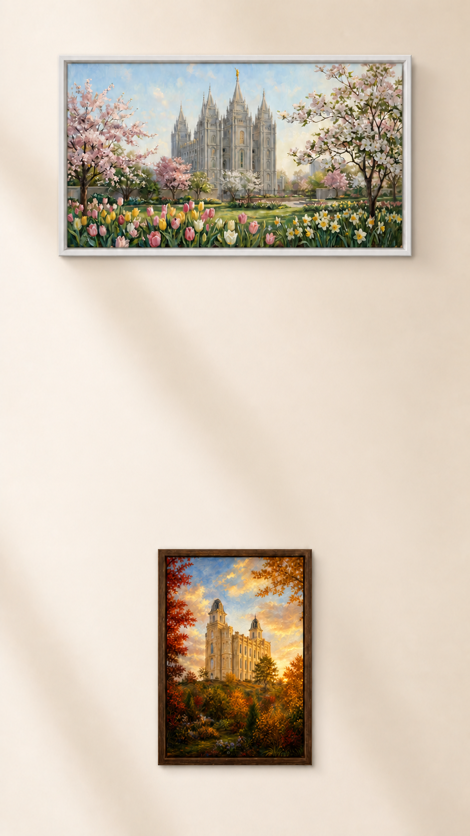 Framed oil paintings of Latter-day Saint temples hung on a warm cream gallery wall